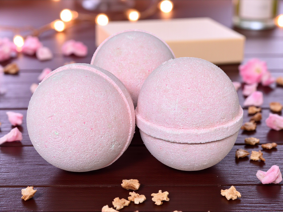 Three bath bombs on a wooden surface with decorative elements