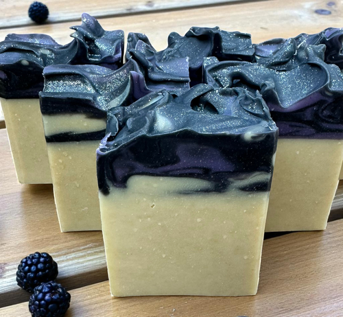 Bar of soap with black and white layers on a wooden surface