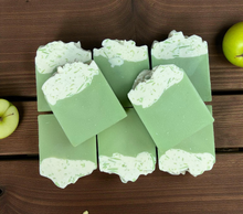 Load image into Gallery viewer, Green soap bars with a textured top on a wooden surface

